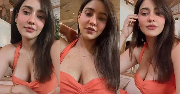 Neha Sharma flaunted ample cleavage in this orange dress - see hot photos. Neha SHarma cleavage orange dress