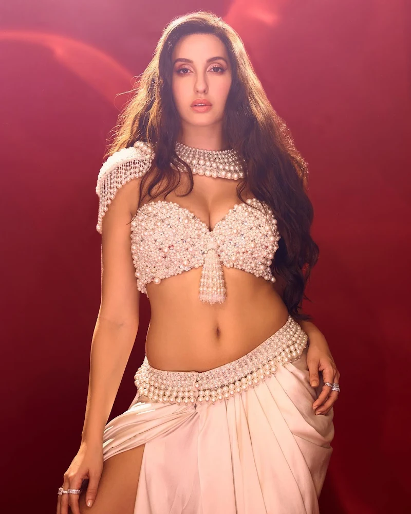 Nora Fatehi is too hot to handle in this cleavage baring skimpy pearl top  revealing her fine midriff - see now. - SpideyPosts