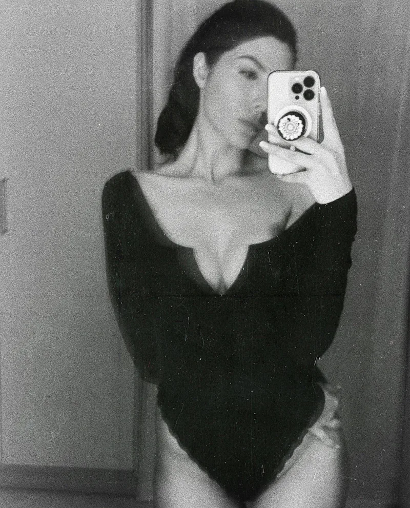 Elnaaz Norouzi black bodysuit cleavage legs