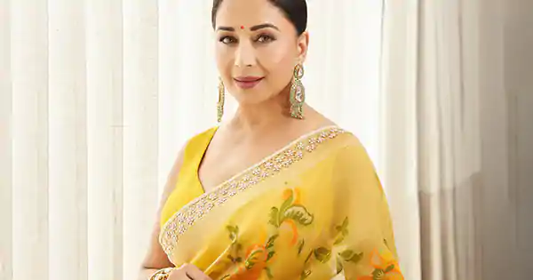 Madhuri Dixit looked breathtaking in yellow saree with sleeveless blouse.